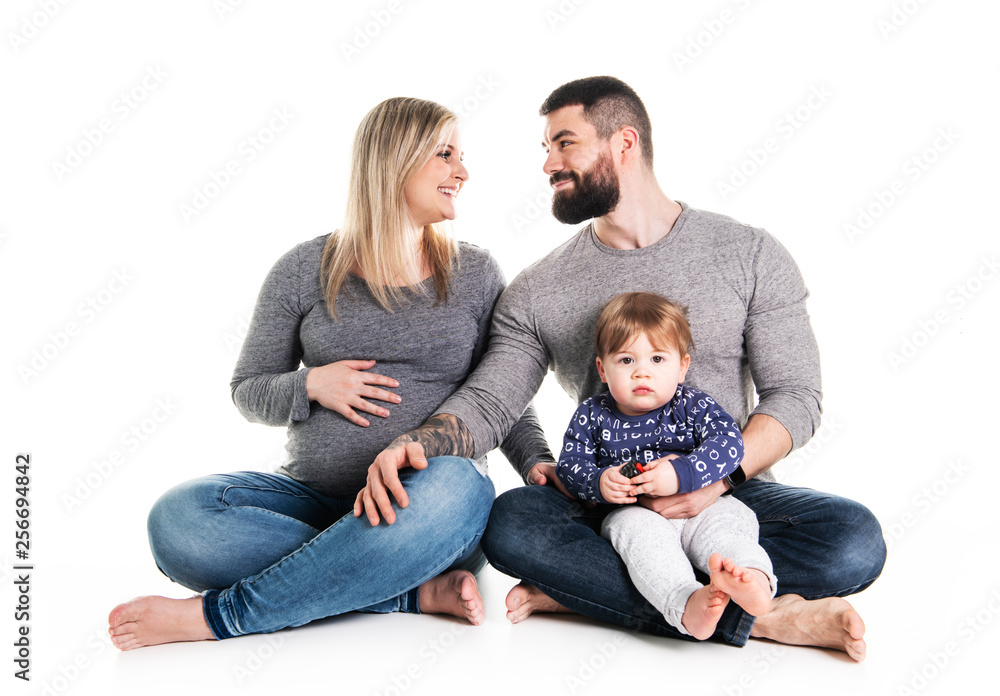 A beautiful happy family with a pregnant mother, the father and a son together A beautiful happy family with a pregnant mother, the father and a son together