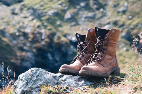 Photography Close up new brown leather shoe on mountain lake view point