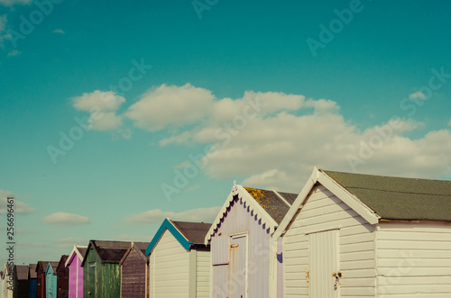 beach huts in england and blue sky with clouds