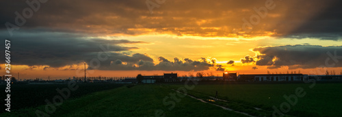 Panoramic view of a colorful sunset over the dutch countryside close to the cities of Rotterdam and Gouda, The Netherlands.