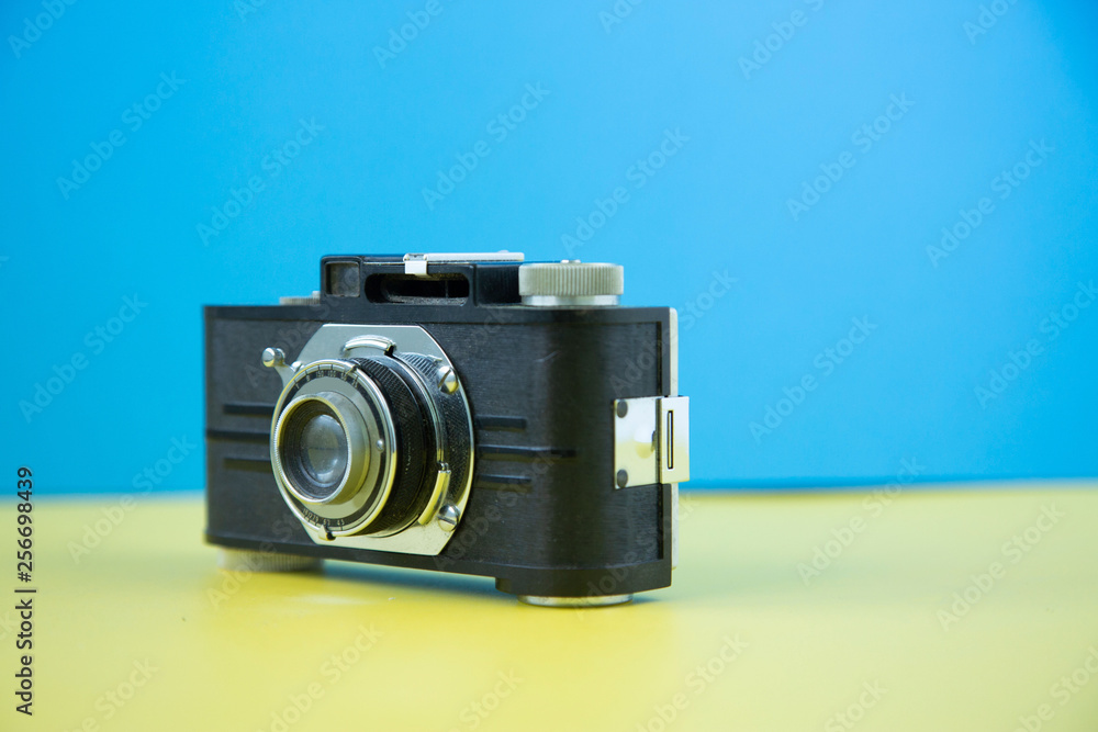 Fototapeta premium A retro vintage camera shot on a colorful background