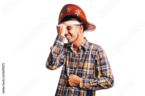 Brazilian man wearing traditional clothes for Festa Junina - June festival - dancing isolated on white background