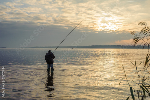 Man catches fish in the water against the sky © Vitaliy