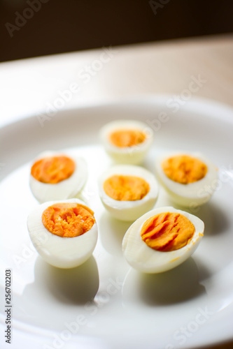 Plate of freshly boiled eggs isolated on wooden table. Aerial view. Copy space. 