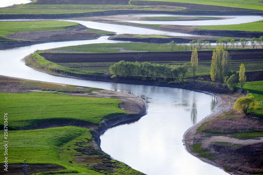 Meandering stream with mountains and clouds at The Persembe Plateau at Ordu, Turkey 