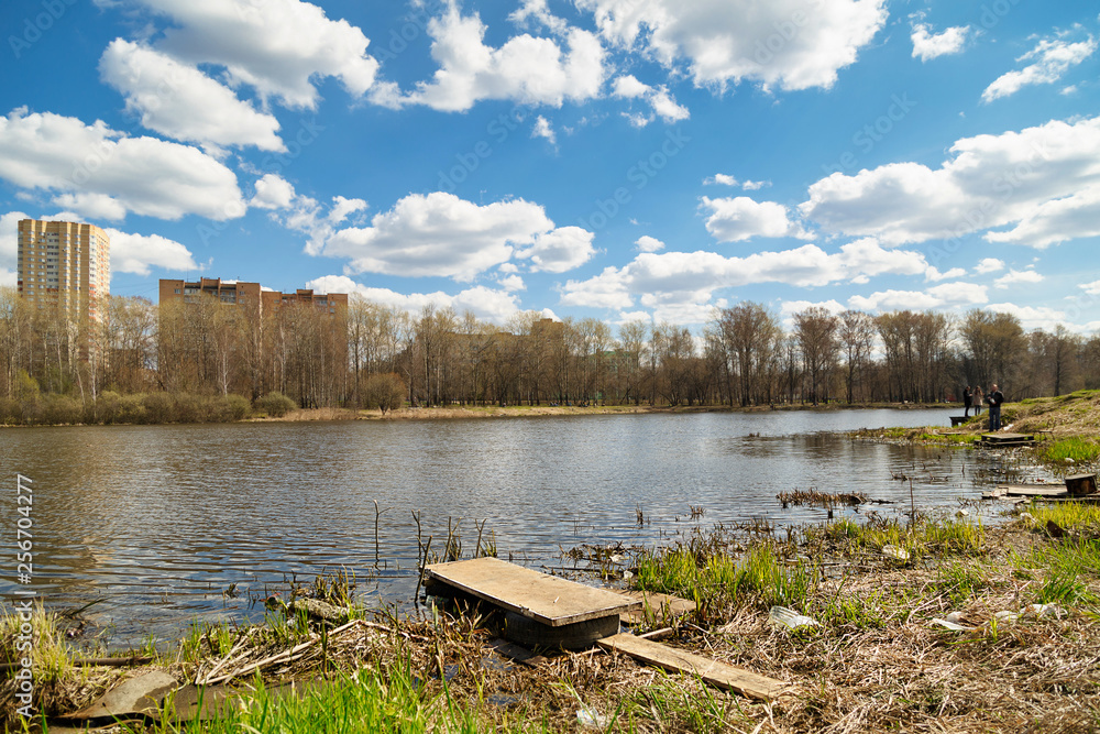 City park on the banks of the Pekhorka river on a sunny spring day. Balashikha, Russia.