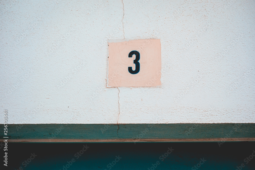 typical mediterranean door sign with number 3 on the top typical mediterranean door sign with number 3 on the top