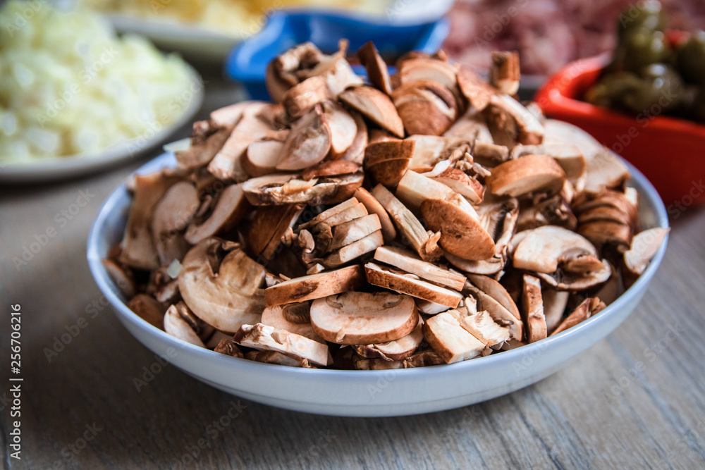 Sliced brown champignon mushrooms in a ceramic bowl Sliced brown champignon mushrooms in a ceramic bowl