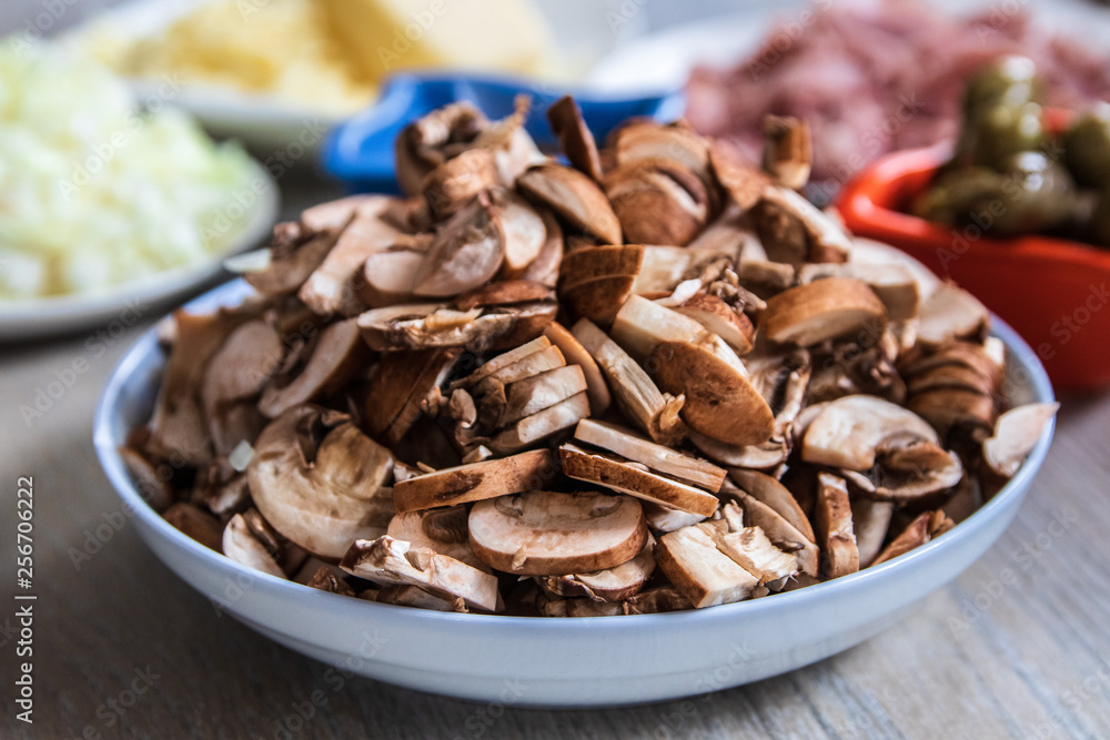 Sliced brown champignon mushrooms in a ceramic bowl Sliced brown champignon mushrooms in a ceramic bowl