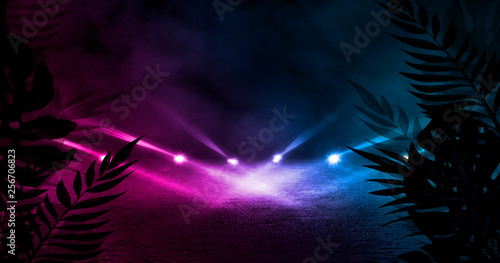 Empty scene background, abstract background with multicolored bokeh and neon lights. Silhouettes of tropical leaves