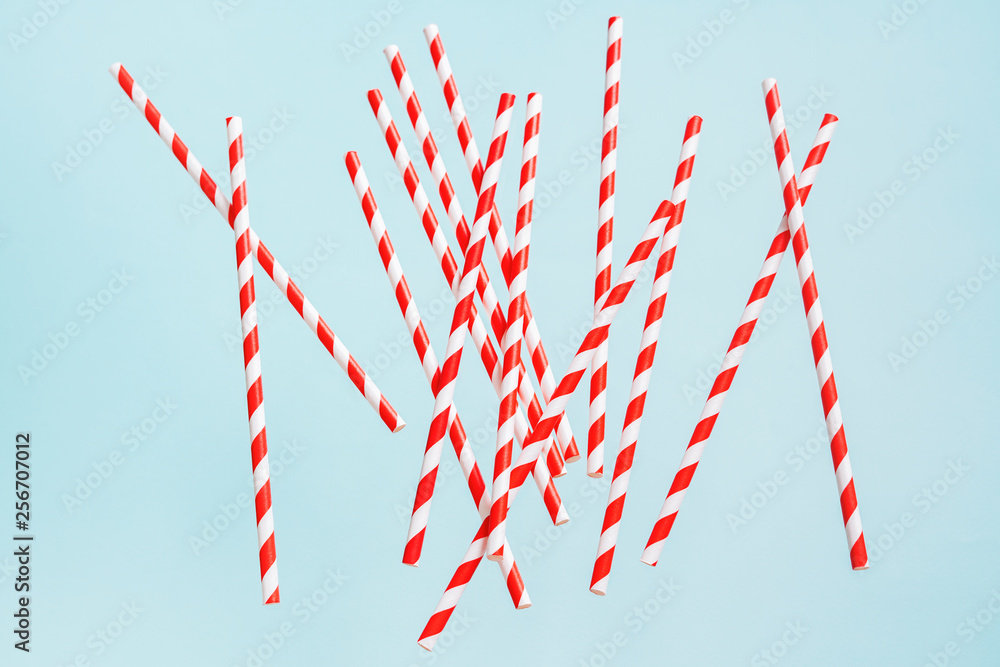 Fototapeta premium Colorful drinking straws for beverage on a bright background. Birthday festive cheerful background.