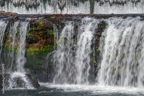 Moss covers the ledges of this flowing waterfall making a colorful scenery.