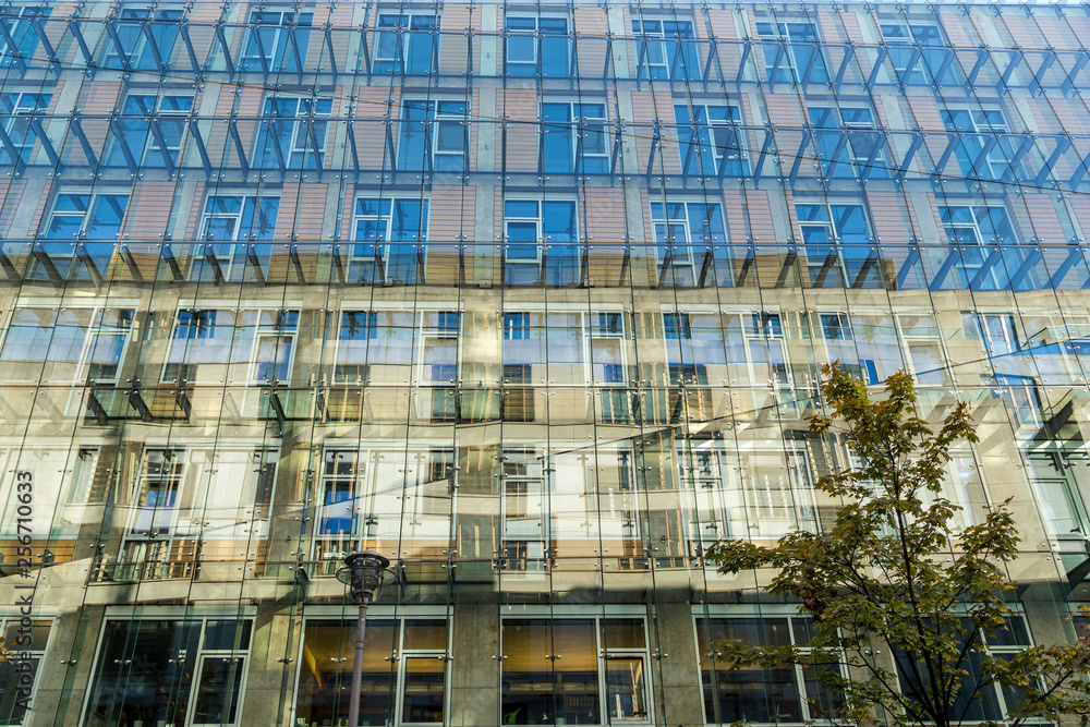 Glass facade with reflection of a building