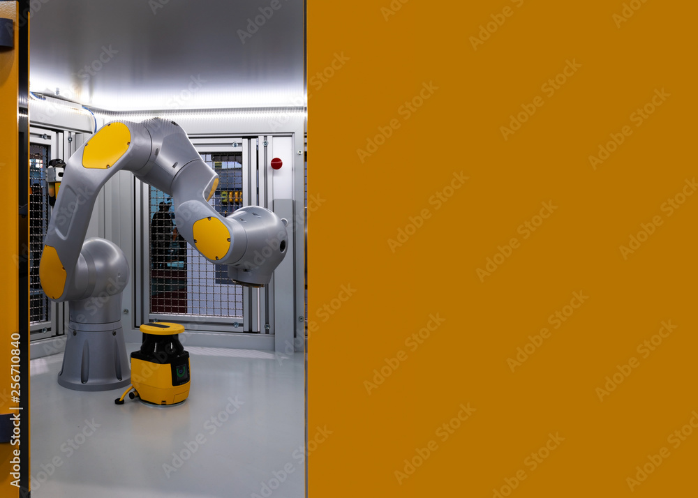 Robot display in metal cage, an industrial robotic arm with copy space