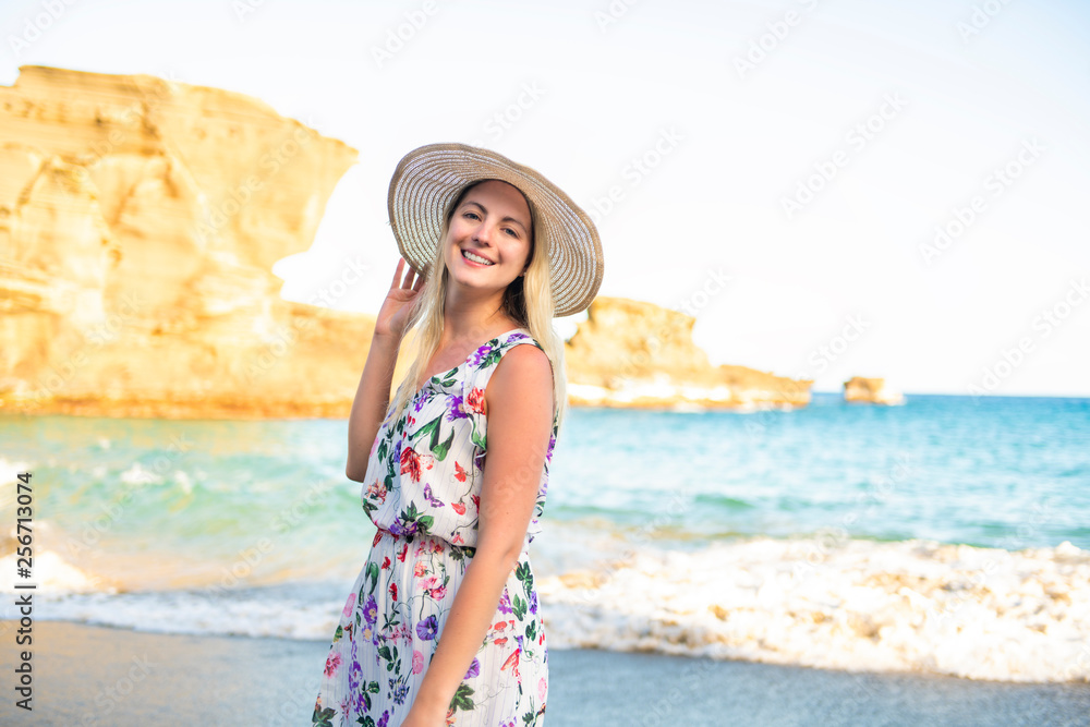 The summer holidays and vacation concept girl in dress standing on the beach The summer holidays and vacation concept girl in dress standing on the beach
