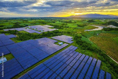 Fototapeta Naklejka Na Ścianę i Meble -  Solar photovoltaic panel base surrounded by aerial green plants
