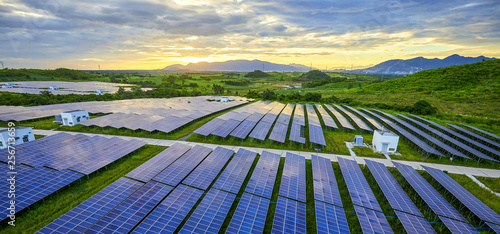 Bild auf Leinwand Solar photovoltaic panel base surrounded by aerial green plants