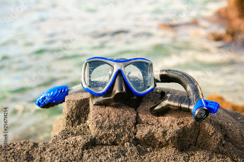Photography A Colorful snorkle or diving mask located on the rocks