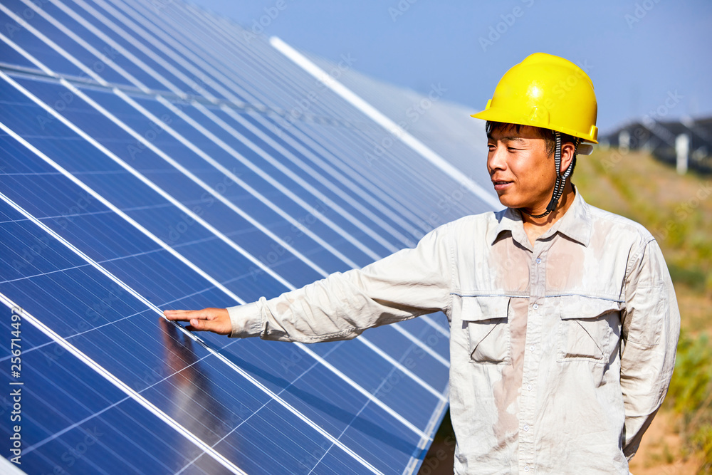 Asian engineers inspected the hot surface of solar photovoltaic panels under the scorching sun Asian engineers inspected the hot surface of solar photovoltaic panels under the scorching sun