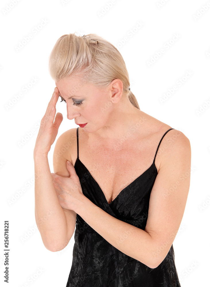 Fototapeta premium Woman looking down hand on head thinking