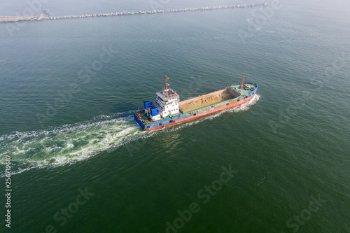 Aerial view of panoramic seaport warehouse and container ship, crane vessel working for delivery of delivery containers. Yuzhny Sea Industrial Port, Port Plant, Ukraine, 2019. Ships in sea port, fog © Aleksandr Lesik