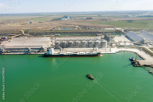Aerial view of panoramic seaport warehouse and container ship, crane vessel working for delivery of delivery containers. Yuzhny Sea Industrial Port, Port Plant, Ukraine, 2019. Ships in sea port, fog