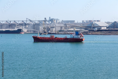 Aerial view of panoramic seaport warehouse and container ship, crane vessel working for delivery of delivery containers. Yuzhny Sea Industrial Port, Port Plant, Ukraine, 2019. Ships in sea port, fog