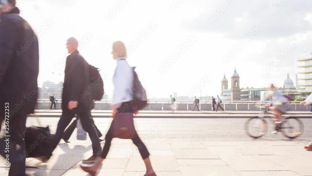 Timelapse of commuters at rush hour backlit by the sun on london bridge london england themes of rush hour commuters routines Timelapse of commuters at rush hour backlit by the sun on london bridge london england themes of rush hour commuters routines