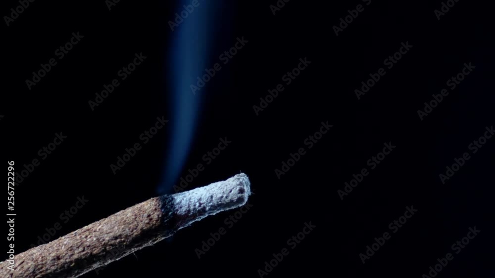 Macro Slow Motion Shot Of A Burning Incense Stick Smoking On Black Background Macro Slow Motion Shot Of A Burning Incense Stick Smoking On Black Background