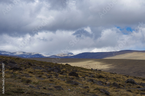 Mount Aragats covered by clouds. View to highland meadow on mountain slope. Armenia.