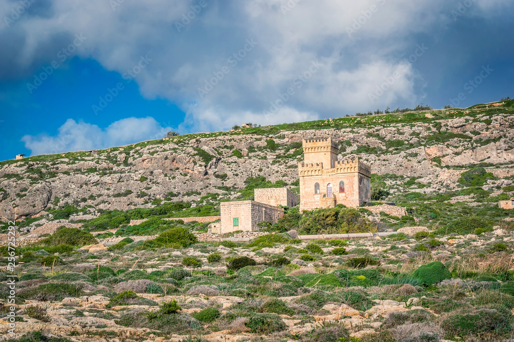 Ghar Lapsi tower on a hilly landscape in Malta. Medieval watchtower