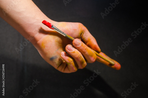 artist holding paintbrush