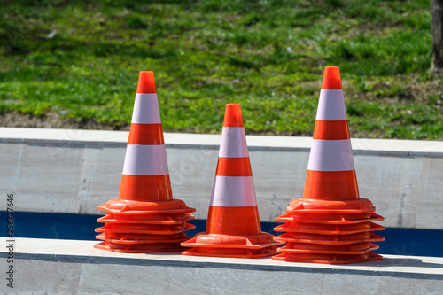 Wallpaper Mural Three stacks of traffic reflective safety cones on red and white on stone Torontodigital.ca