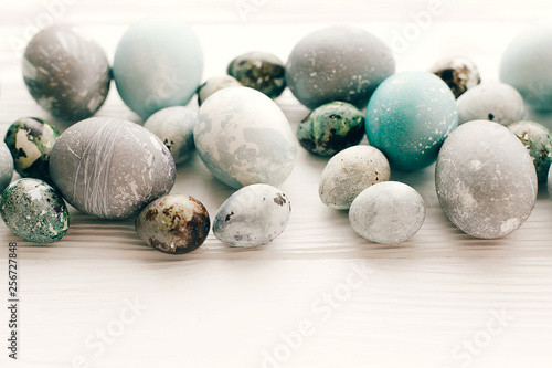 Stylish Easter eggs on white wooden background with space for text. Modern easter eggs painted with natural dye in blue and grey marble. Happy Easter, greeting card image