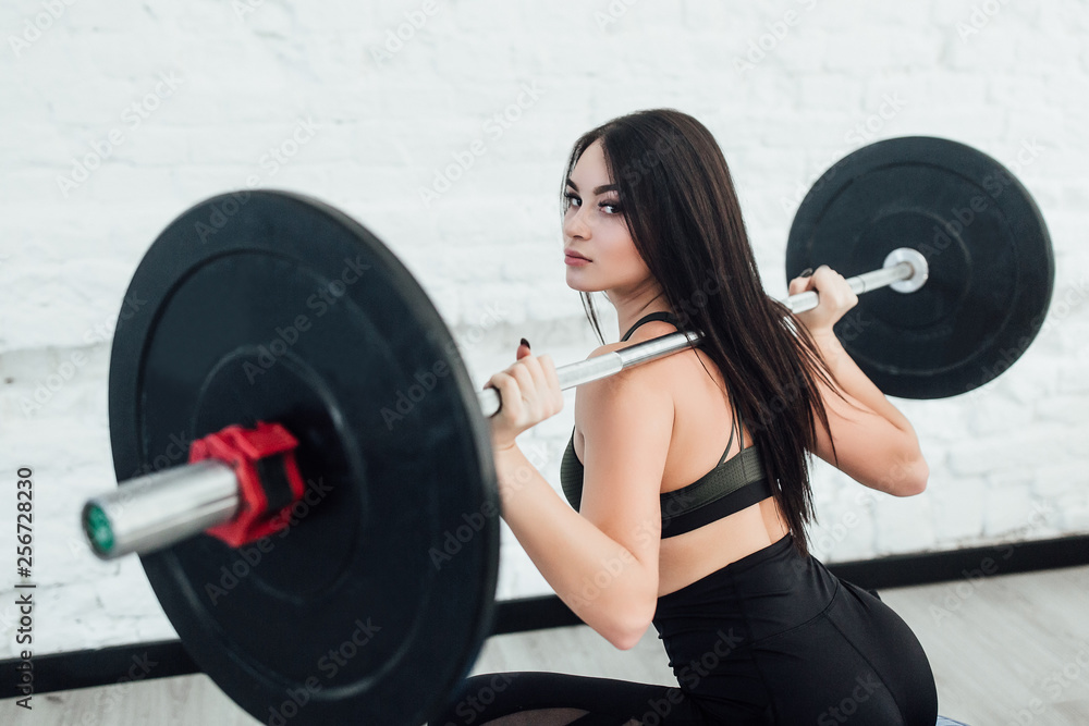 young woman working out with dumbbells in the gym young woman working out with dumbbells in the gym