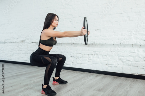 brunette caucasian woman exercising fitness body building exercises