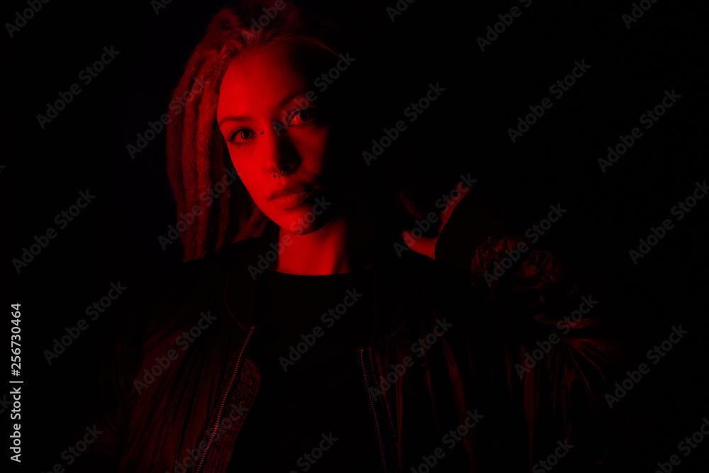 beautiful girl in the light of neon colored lamps light red on black background beautiful girl in the light of neon colored lamps light red on black background