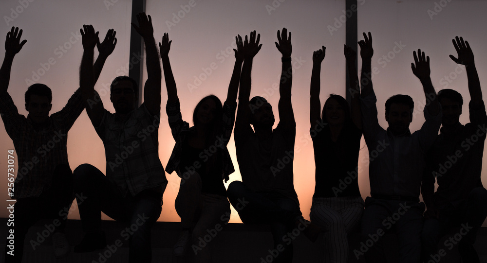 Fototapeta premium group of positive young people sitting on a windowsill.