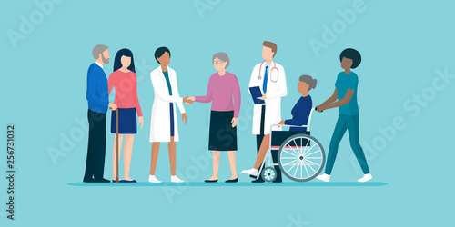 Seniors with team of professional caregivers and doctors