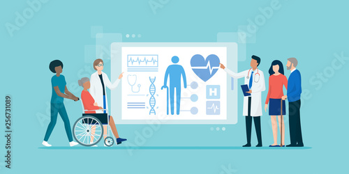Medical team examining senior patients using a tablet