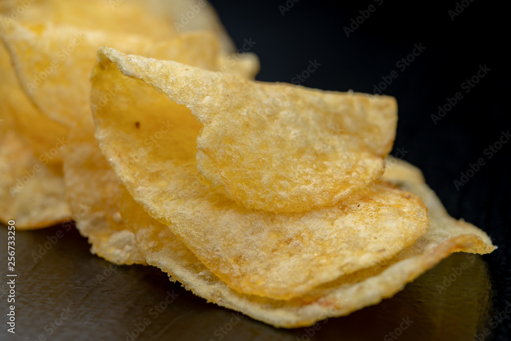 Tasty crisps on the kitchen table. Salty snacks as an addition to beer. Tasty crisps on the kitchen table. Salty snacks as an addition to beer.