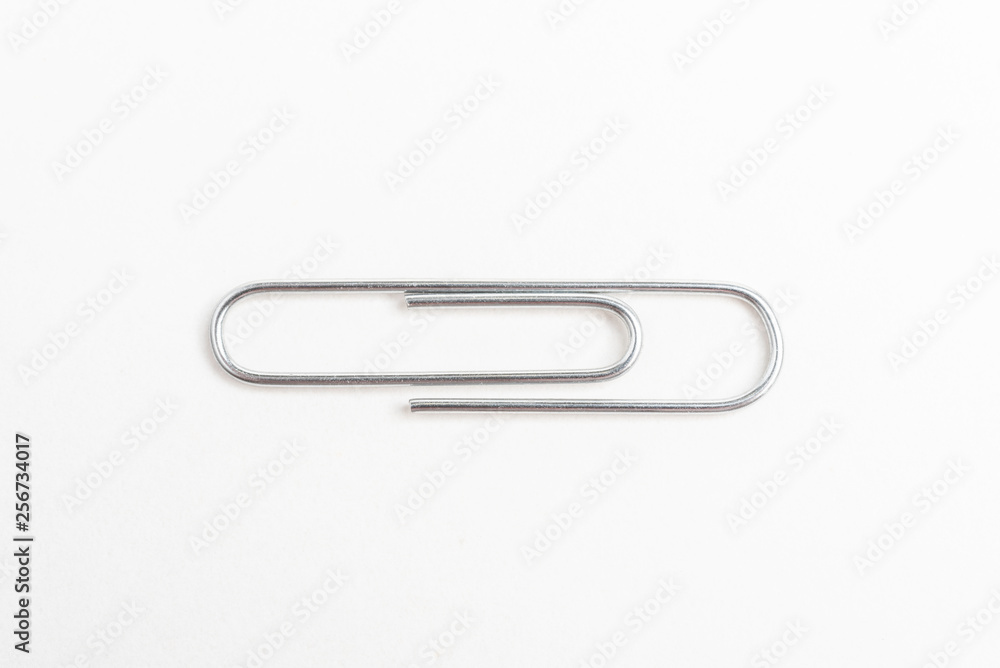 A horizontal macro shot of a common paper clip set on a white background. A horizontal macro shot of a common paper clip set on a white background.