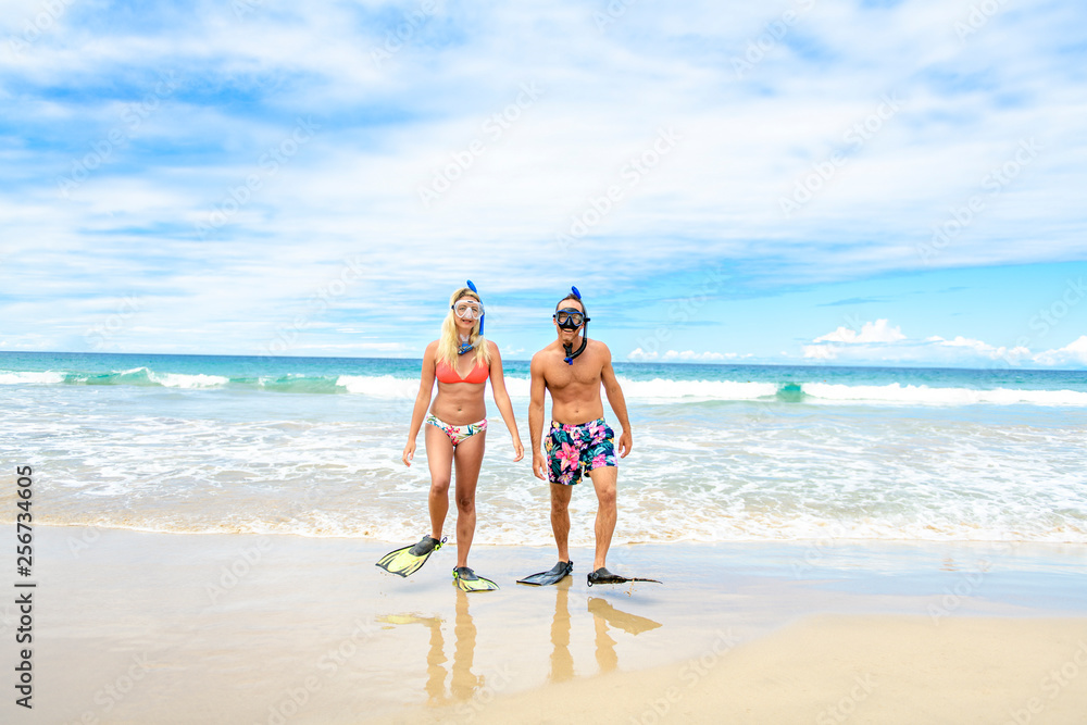 Couple on the beach is going to swim and snorkle on hawaii beach Couple on the beach is going to swim and snorkle on hawaii beach
