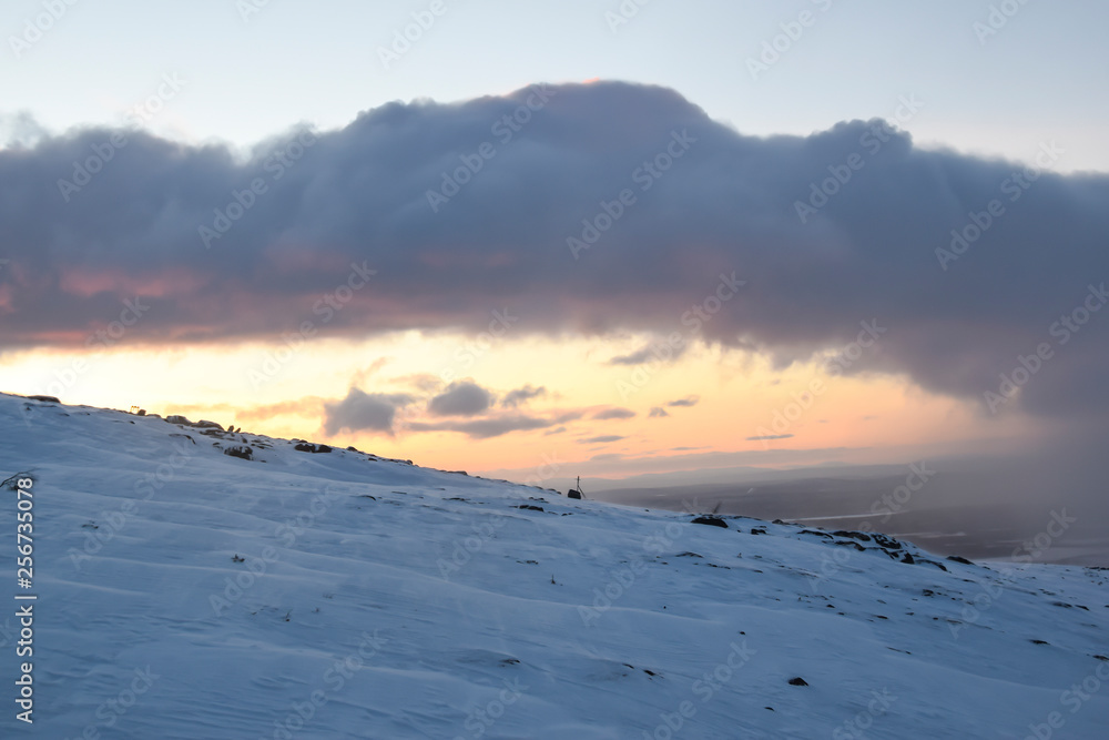 sunset in the mountains in the tundra everywhere white snow nobody landscape road