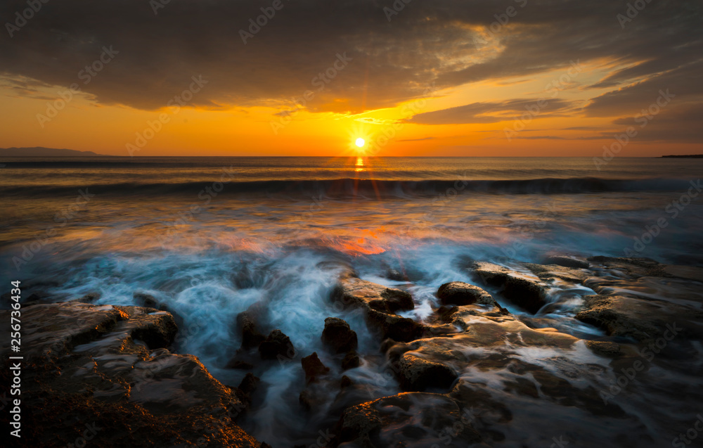 raging sea at sunset taken with long exposure