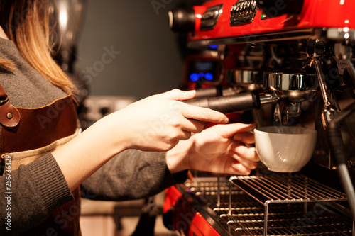 woman using coffee machine at cafe