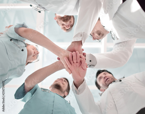 Health care workers demonstrating unity, bottom view