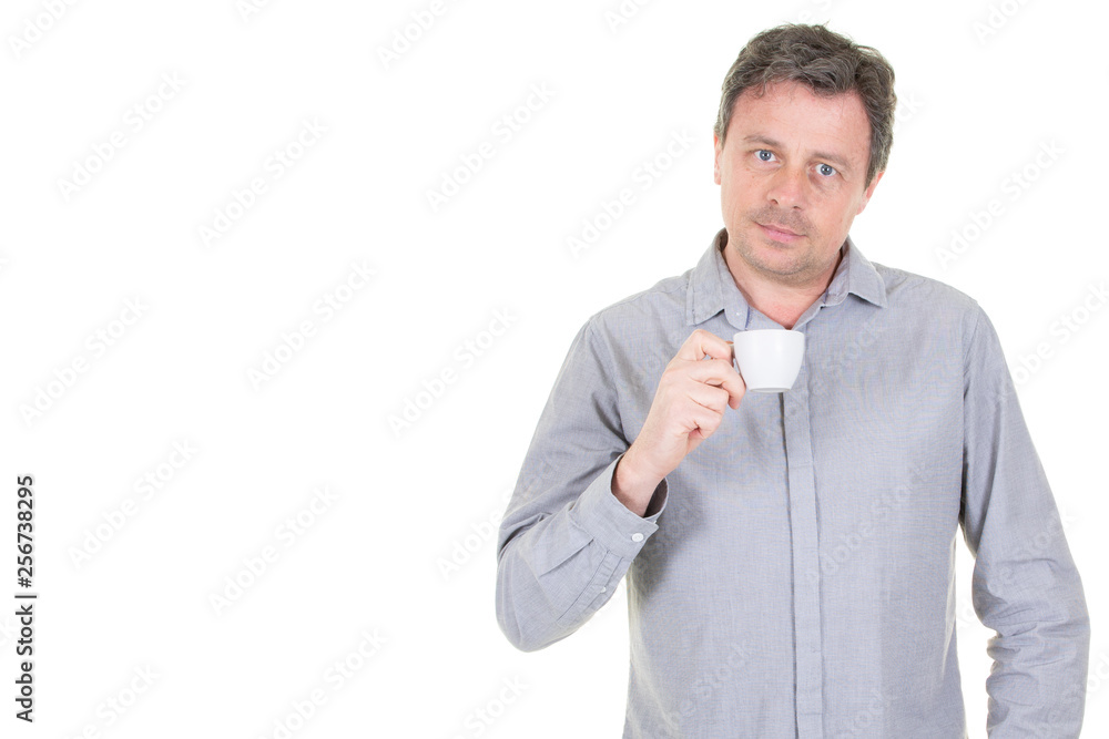 handsome man holding cup with coffee tea with serious face and white copy space background handsome man holding cup with coffee tea with serious face and white copy space background