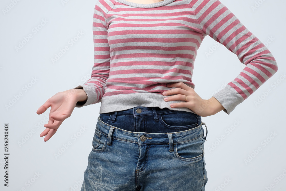 Woman wearing two jeans pants. Strange and odd fashion. She is very sloppy  Stock Photo | Adobe Stock