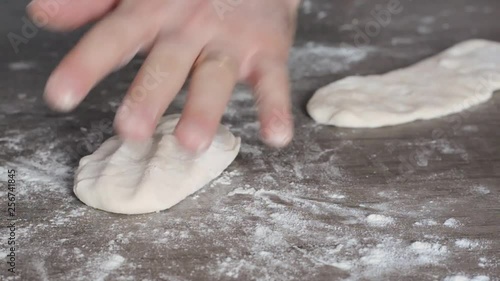 Close up of hands of a man who prepares bread dough made at home .